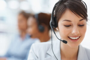 Smiling call center employee during a telephone conversation - Connected Services